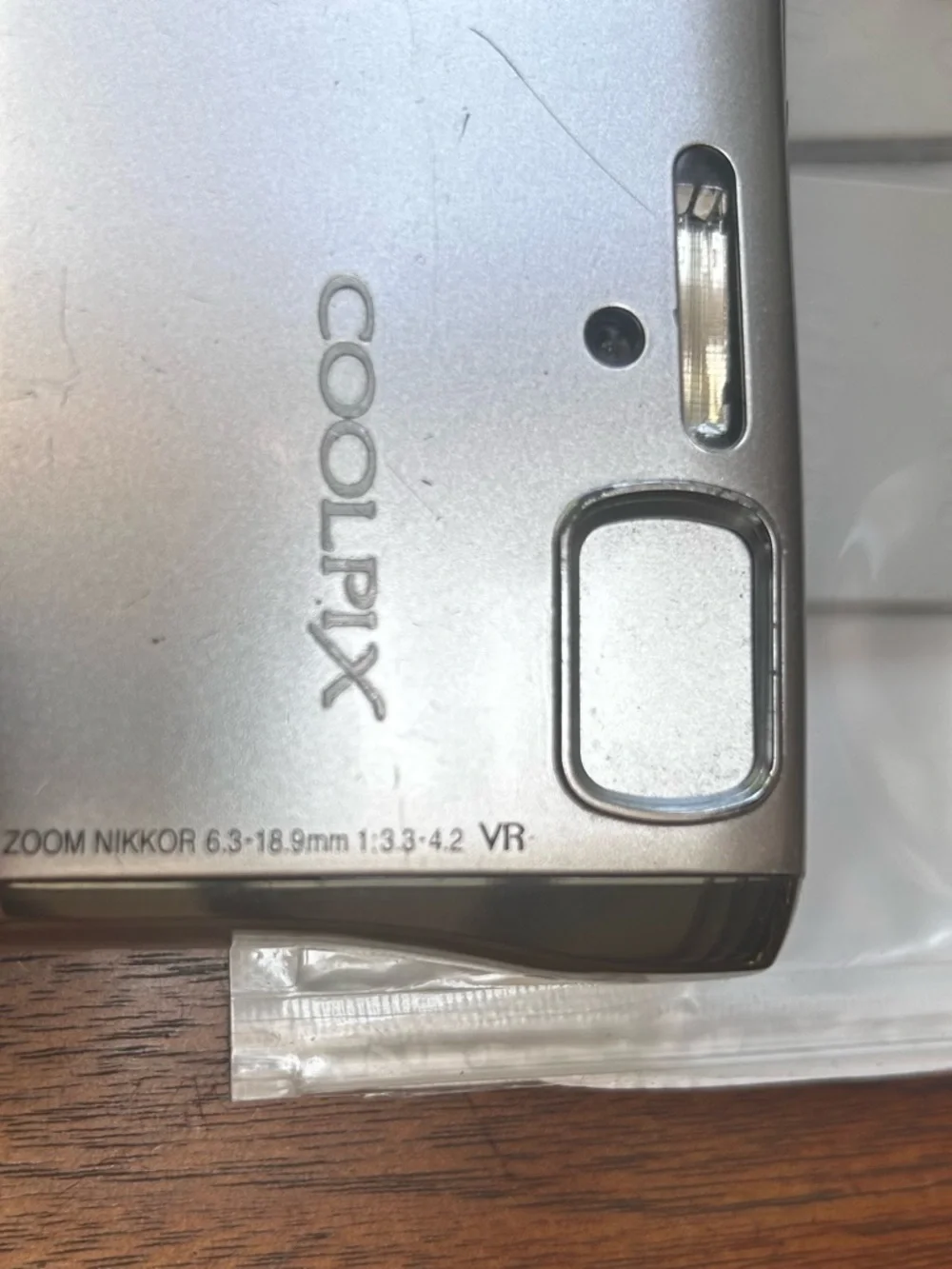 Three NEW lithium ion batteries; used charger for Nikon Coolpix camera.
